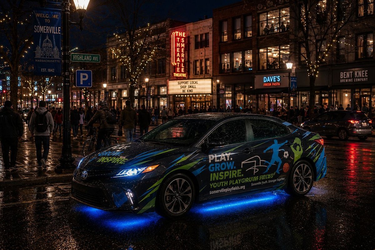 Campaign concept showing a branded vehicle moving through a Somerville MA street at night — downtown presence
